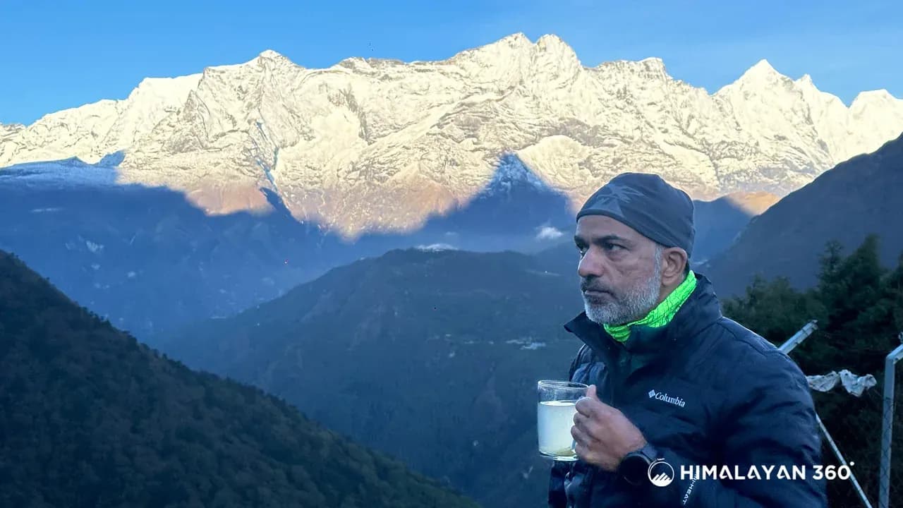 A man in EBC holding a cup