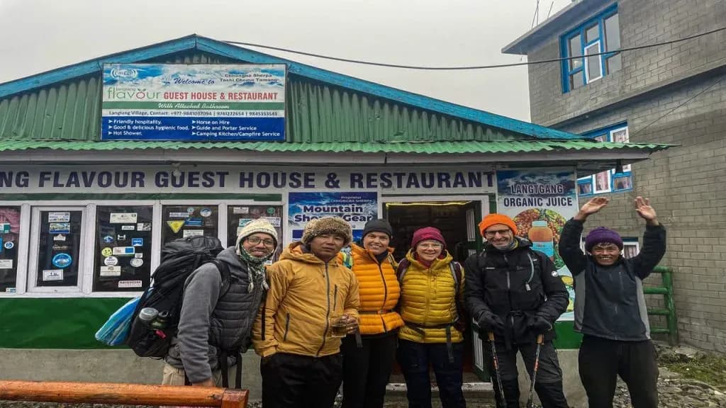 group of visitors posing in front of langtang guesthouse