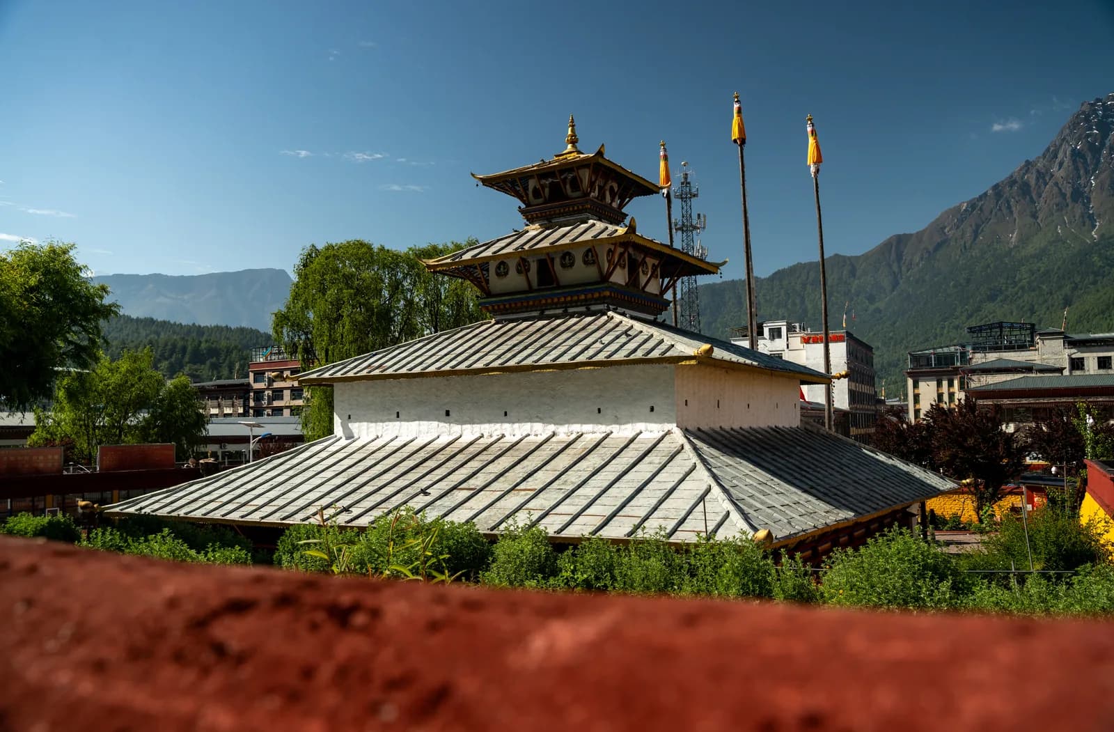 Pakba Monastery roof and prayer poles in Kyirong