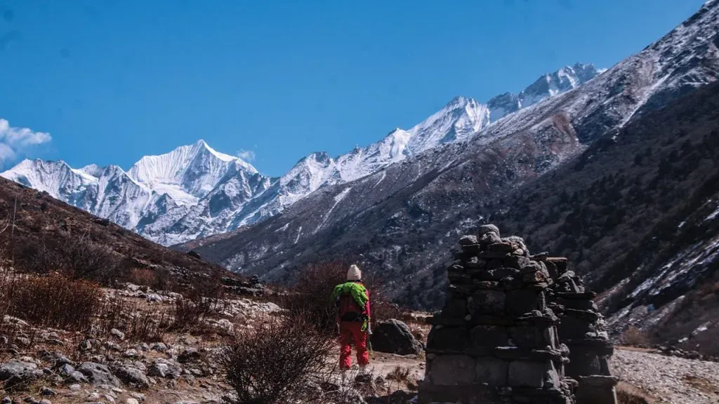 Trekker below snow‑clad Langtang Lirung ridge