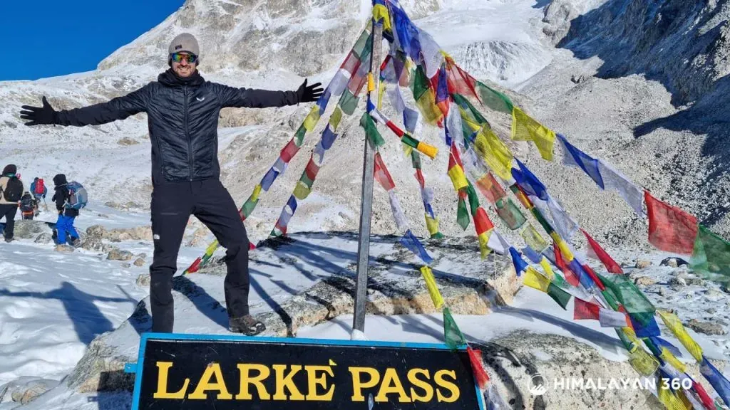 Trekkers are enjoing at the top of Manalsu circuit trek. we can clear see beautiful mountain and colourful prayers flag.